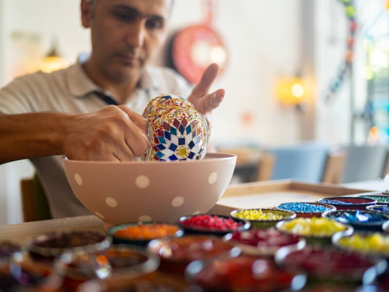 Man making a mosaic bowl